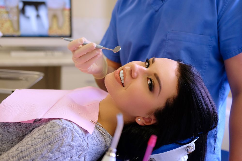 dentist hands working young woman patient with dental tools