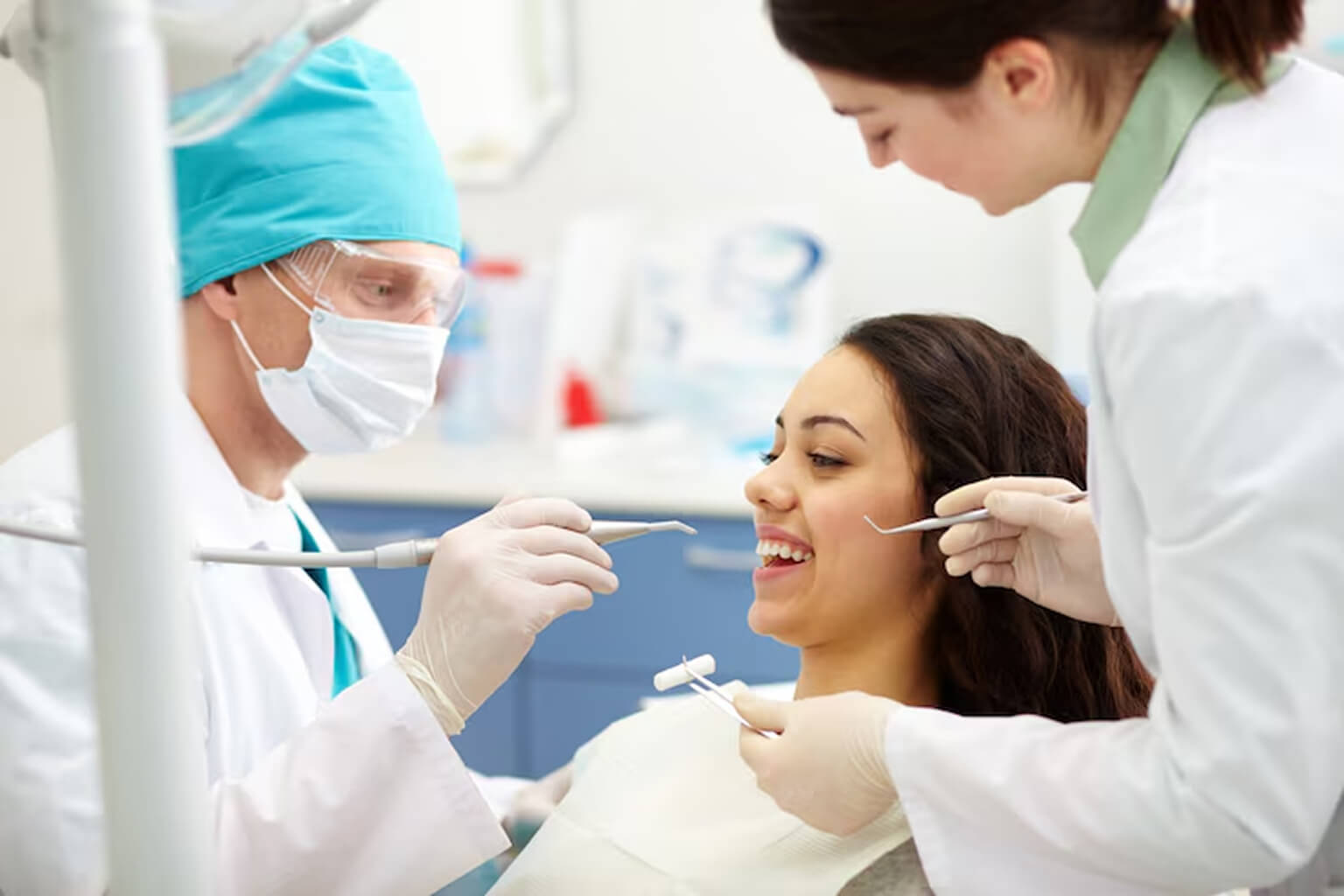 a lady is smiling during getting dental treatment