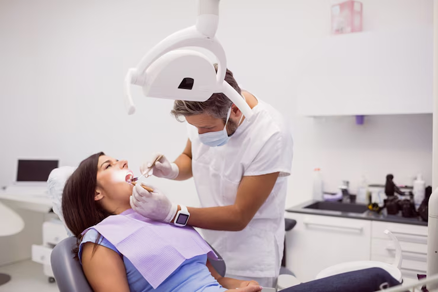 a women getting dental care treatment from a dentist