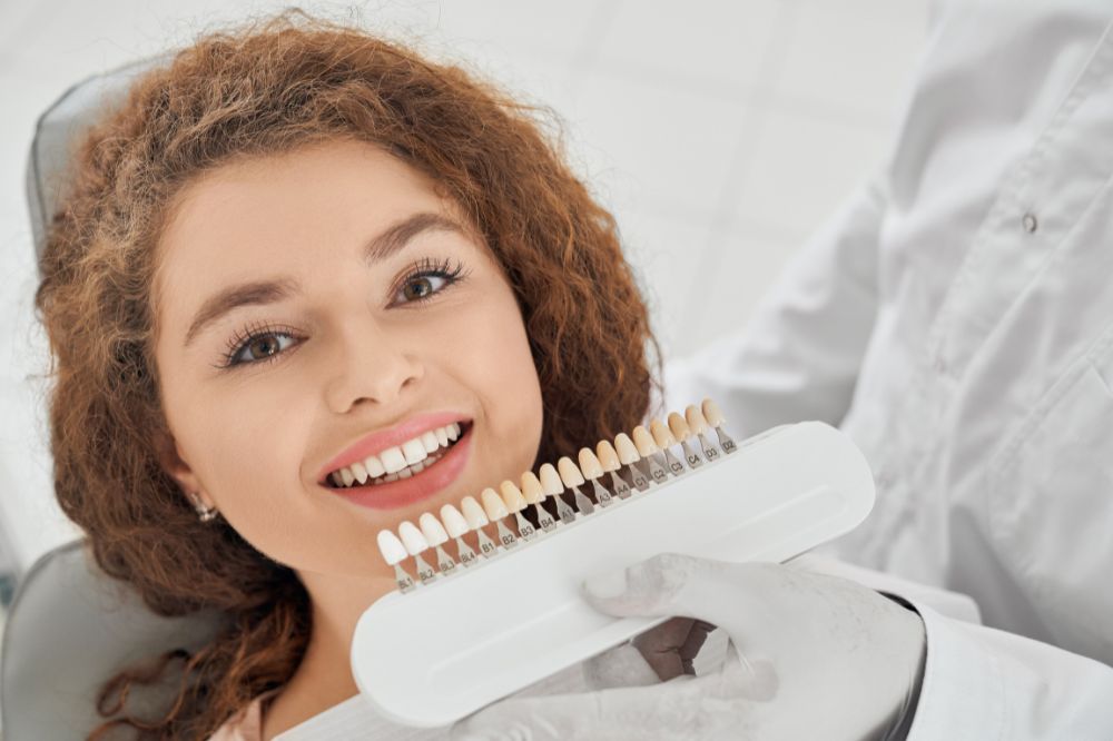 a lady dentist checking dental crowns on a patient