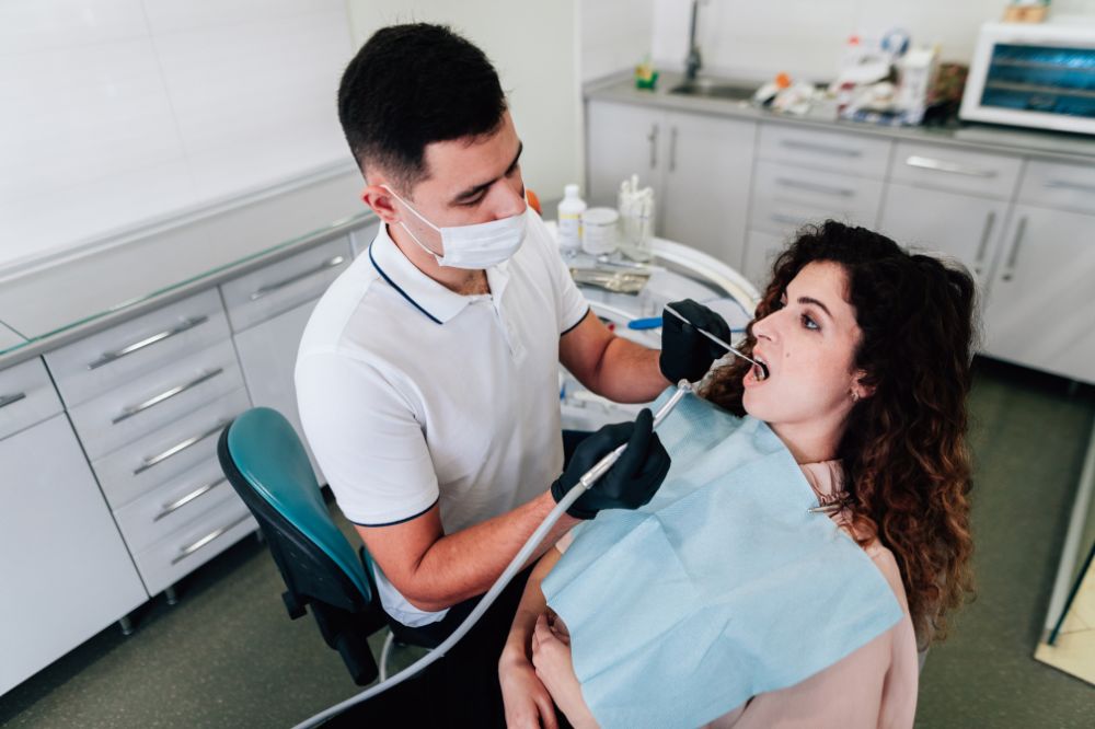 a lady is having teeth extraction treatment
