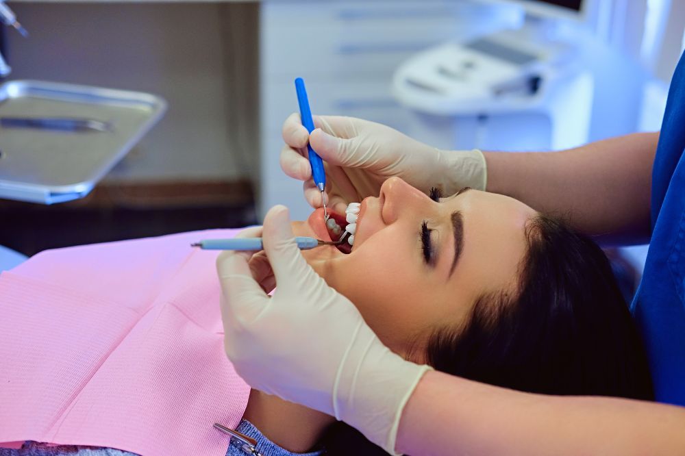 a lady is having tooth extraction treatment