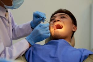a young men is having tooth extraction treatment
